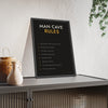 Man Cave Rules Print framed and leaning on a sideboard