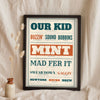 Manchester Slang Print in a black frame propped up on linen