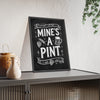Mine's A Pint Chalkboard Print framed and leaning on a sideboard