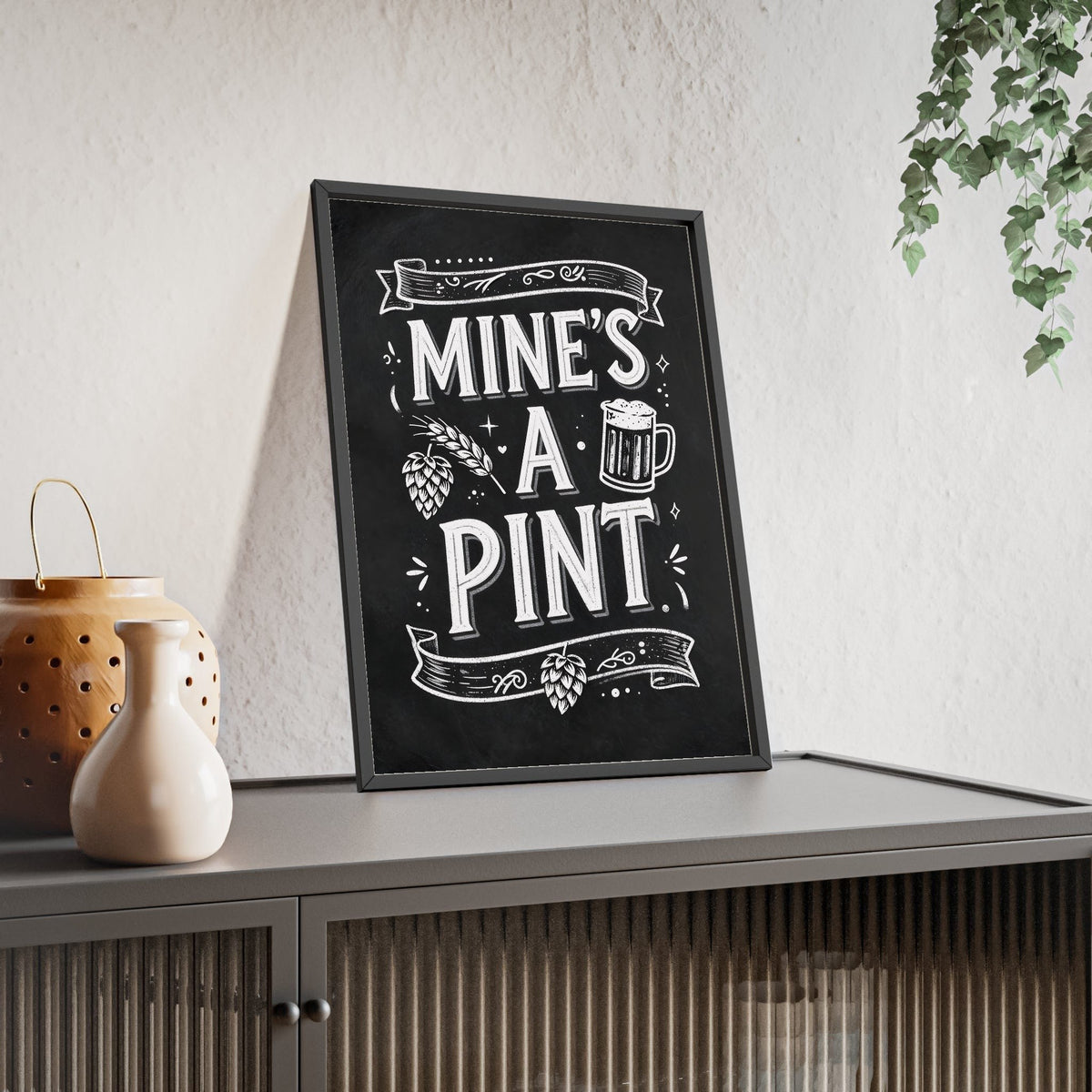 Mine's A Pint Chalkboard Print framed and leaning on a sideboard