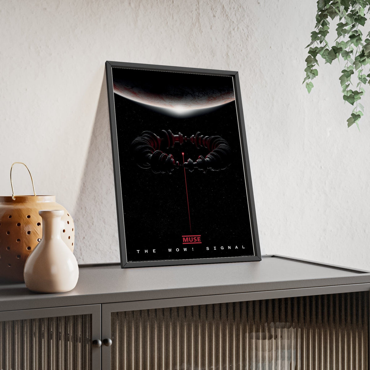 Muse The Wow! Signal Maxi Poster framed and leaning on a sideboard