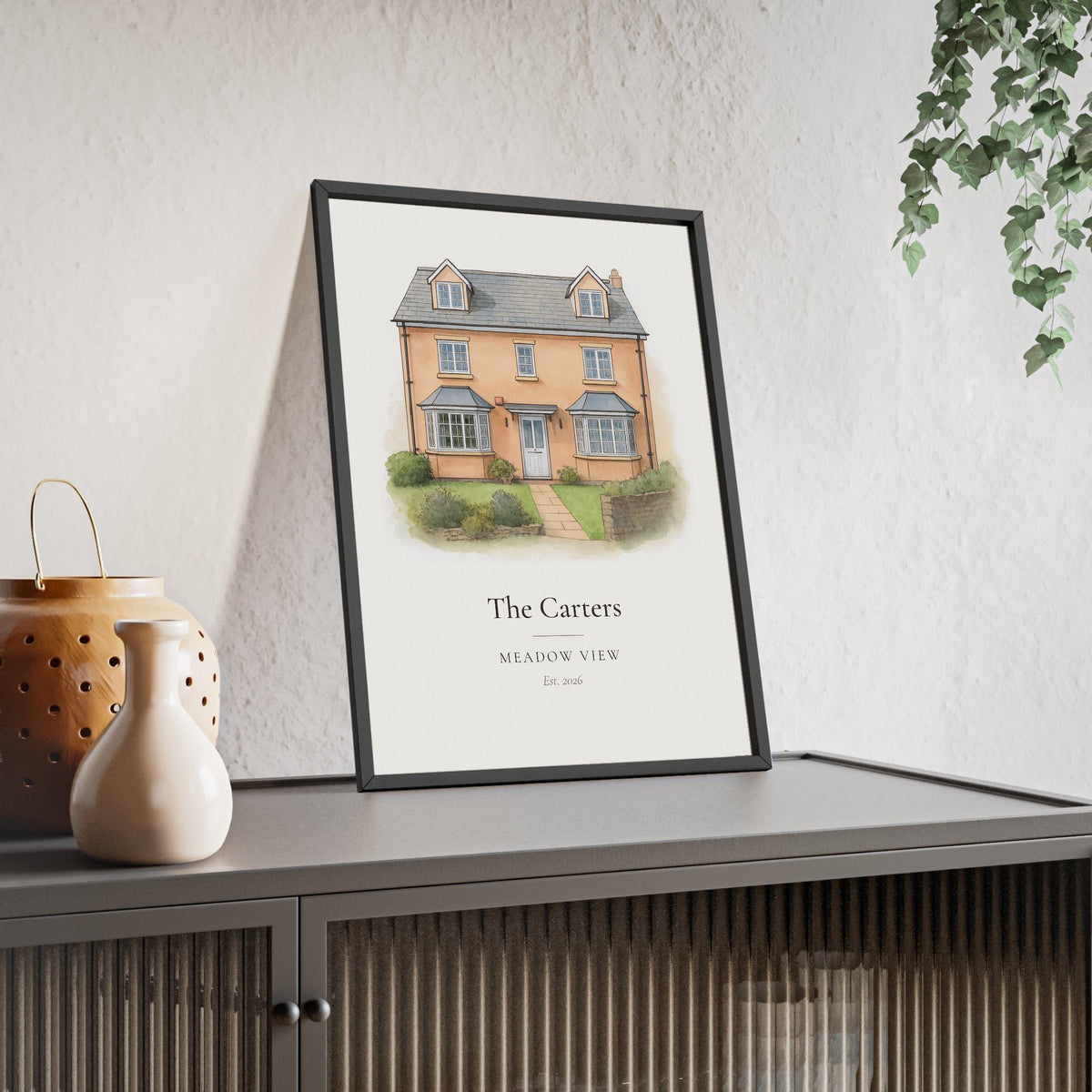 Watercolour house portrait print of a detached new build home, personalised with family name, framed on a sideboard