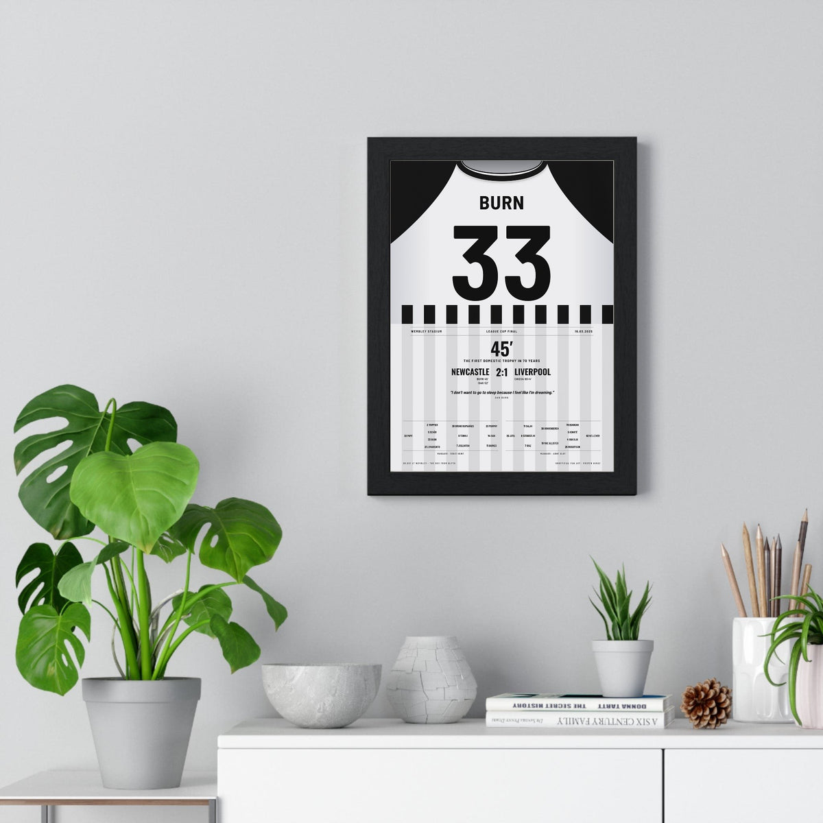 Newcastle United Carabao Cup Final 2025 Poster - Dan Burn 33 Wembley framed on a living room wall