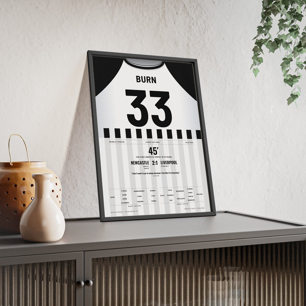 Newcastle United Carabao Cup Final 2025 Poster - Dan Burn 33 Wembley framed and leaning on a sideboard