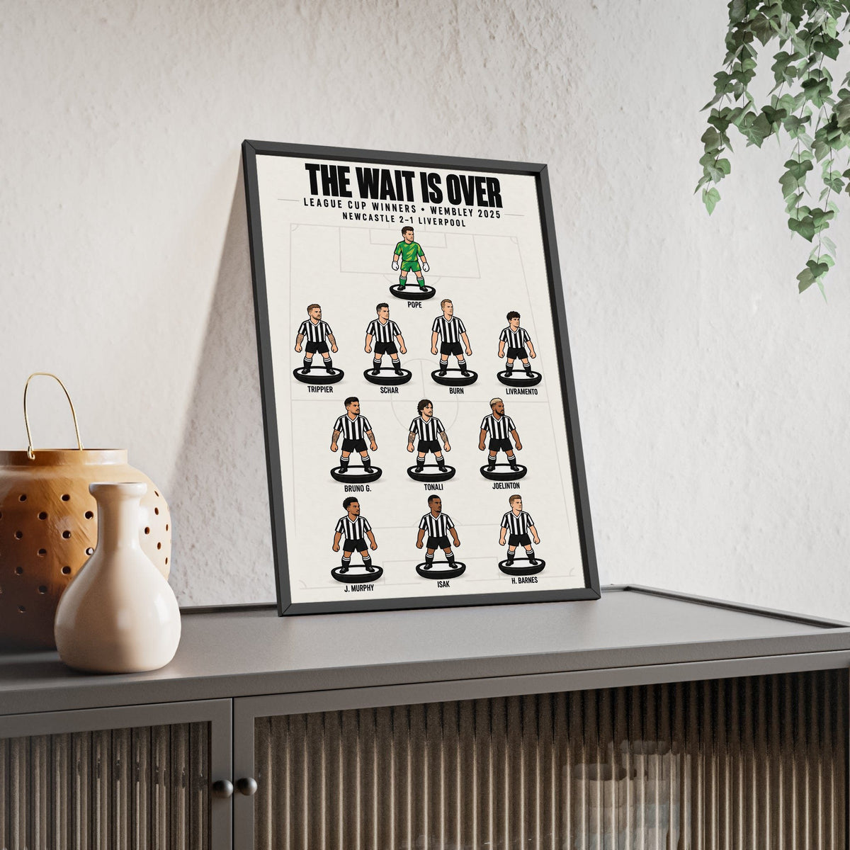 Newcastle United League Cup 2025 XI framed print leaning on a sideboard