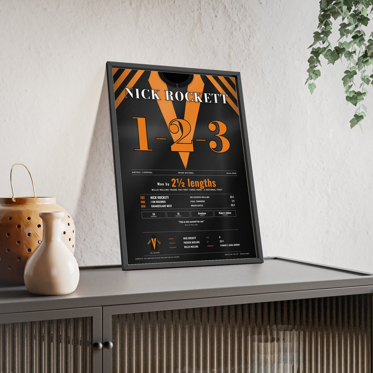 Nick Rockett Grand National 2025 Horse Racing Poster - Mullins 1-2-3 Silks Print framed and leaning on a sideboard