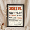 Norfolk Slang Print in a black frame propped up on linen