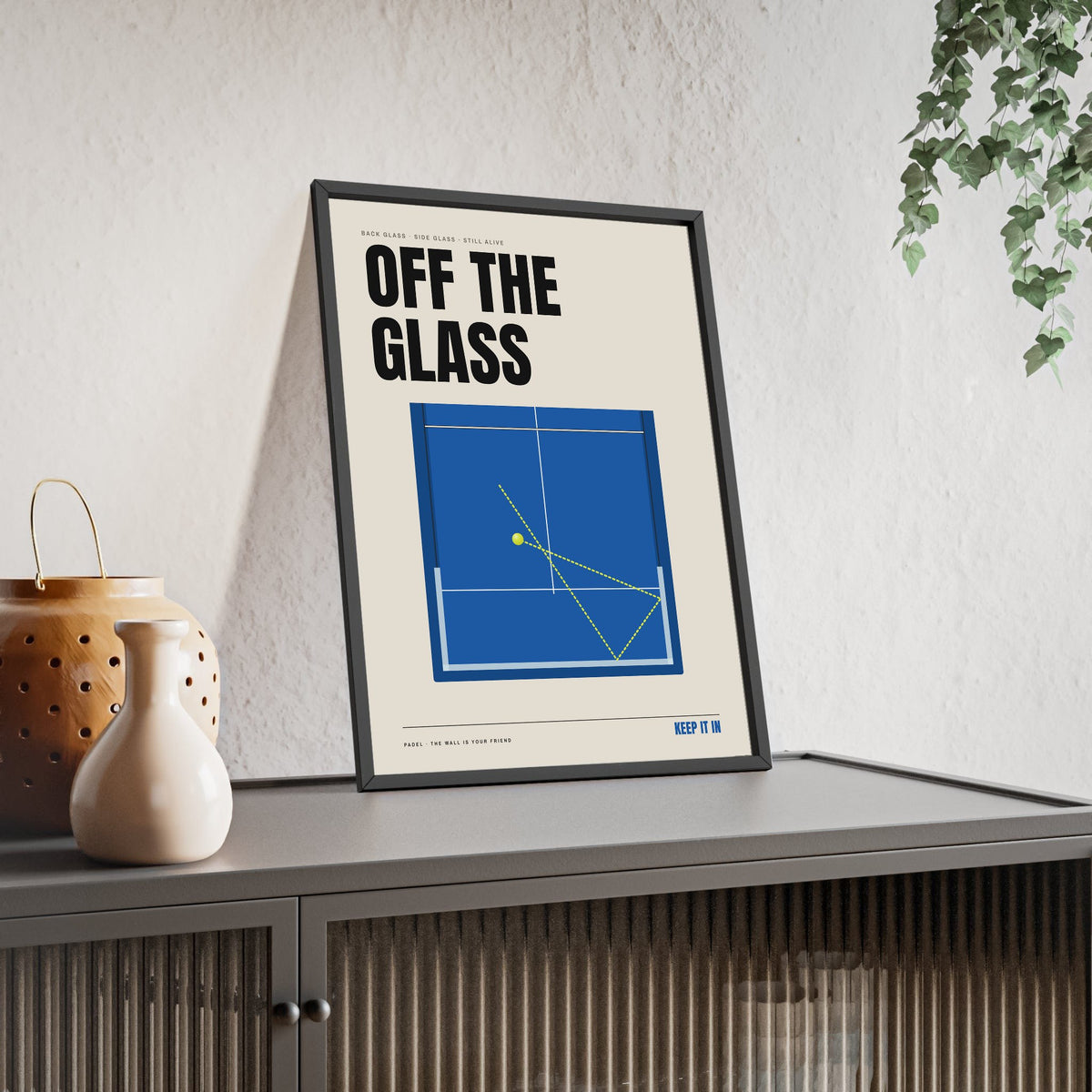 Off The Glass Padel print framed and leaning on a sideboard