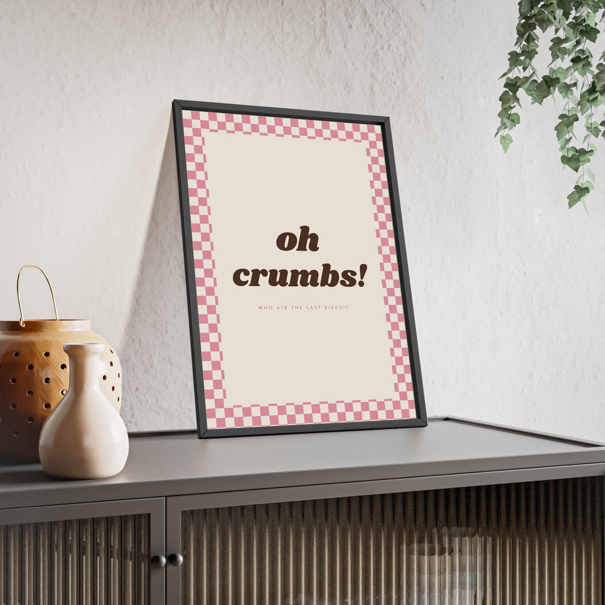 Oh Crumbs Print framed and leaning on a sideboard