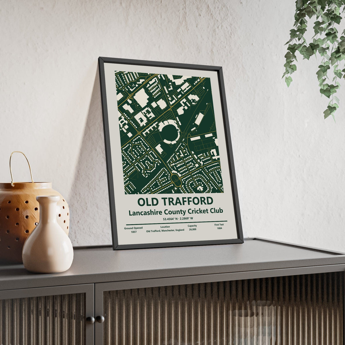 Old Trafford map print framed and leaning on a sideboard