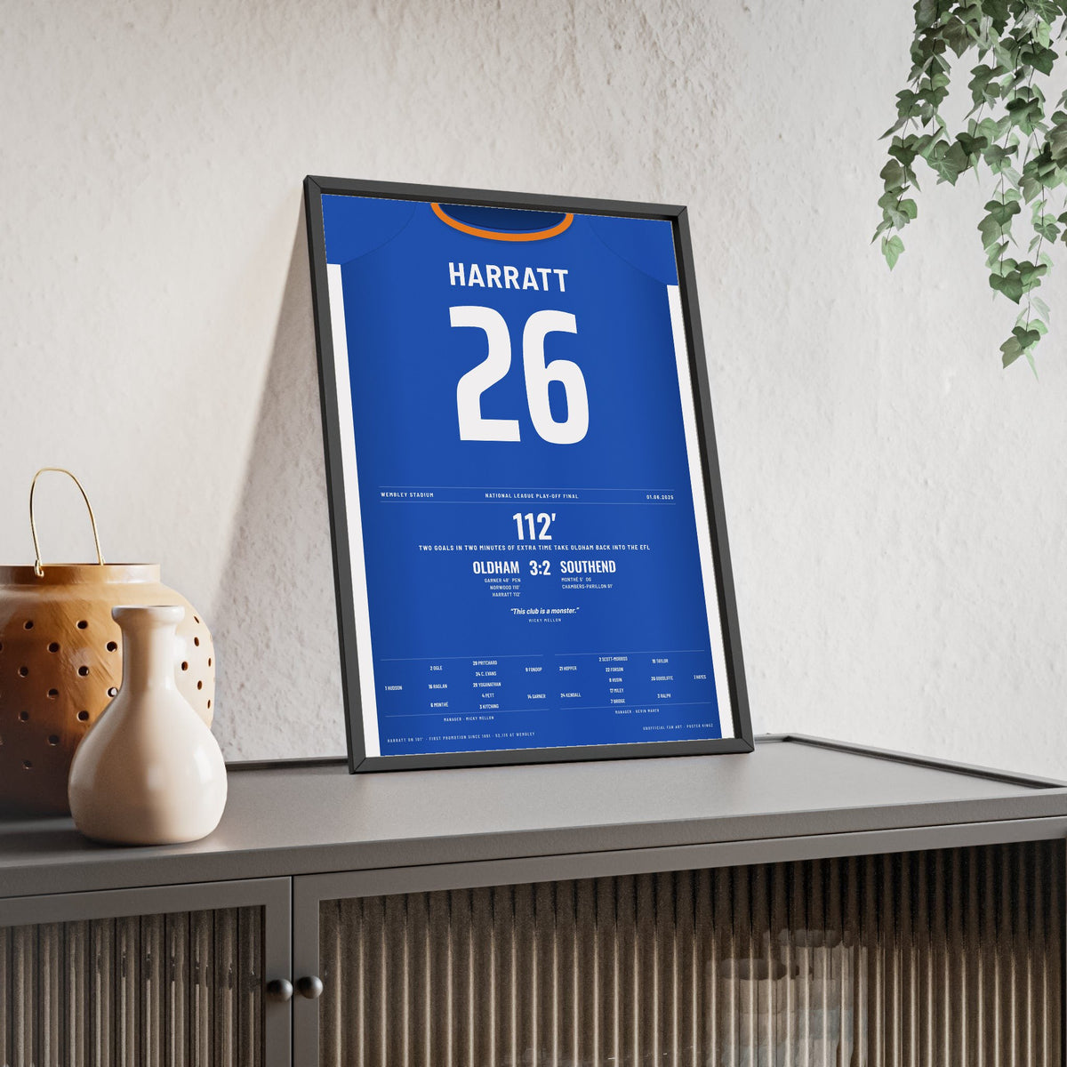 Oldham Athletic Play-Off Final 2025 Poster - Kian Harratt 26 Wembley Shirt Print framed and leaning on a sideboard