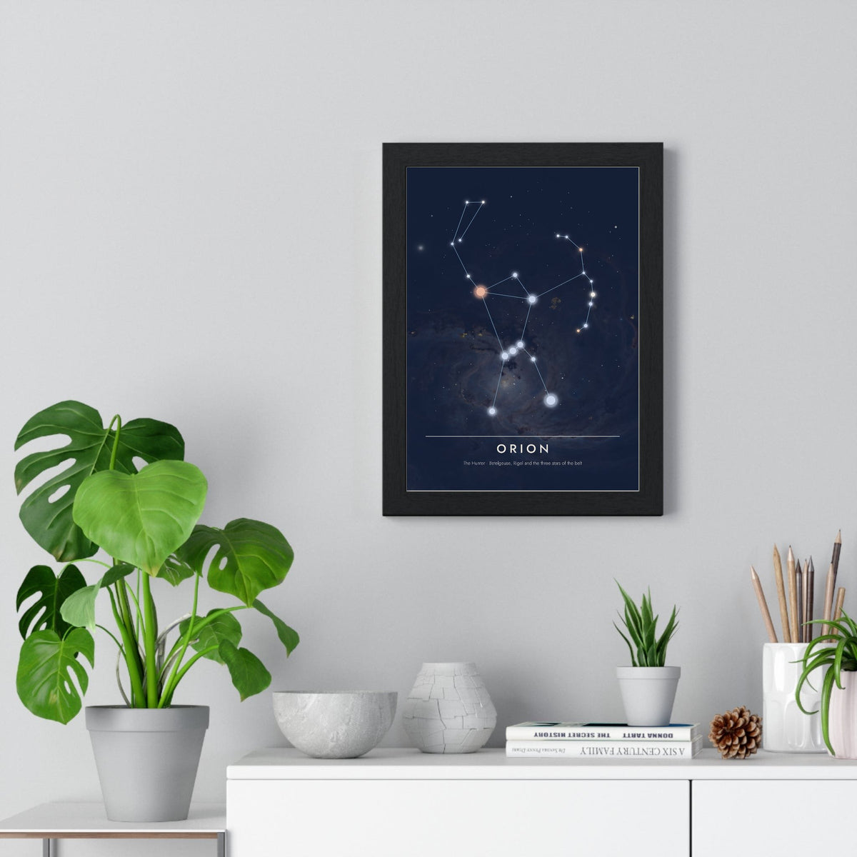 Orion Constellation print framed on a living room wall