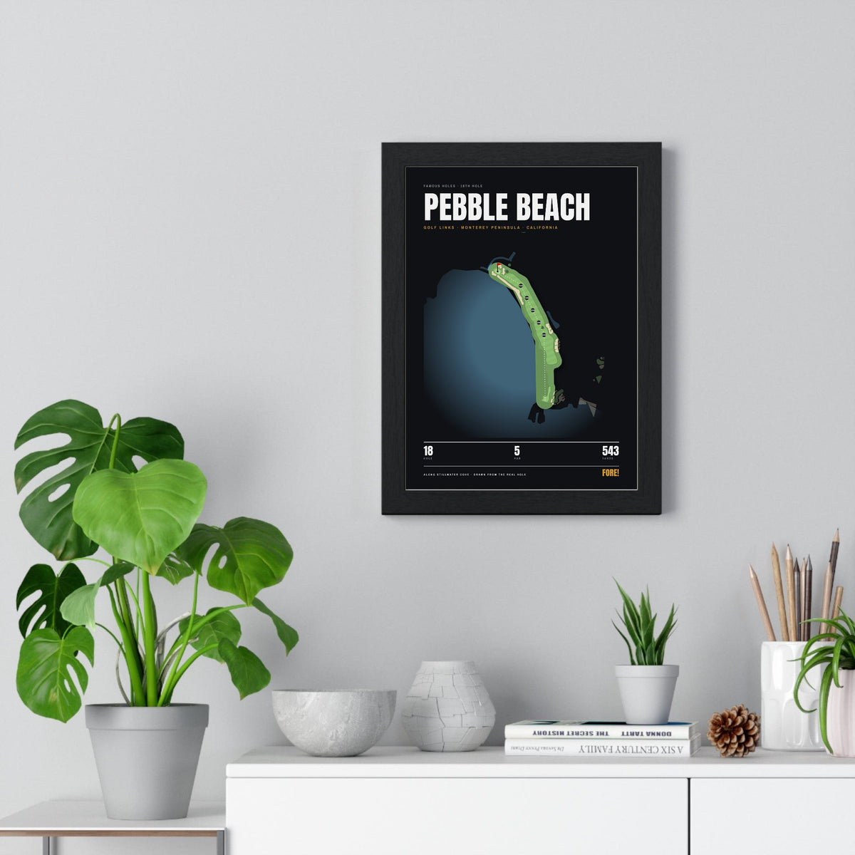 Pebble Beach 18th Hole print framed on a living room wall