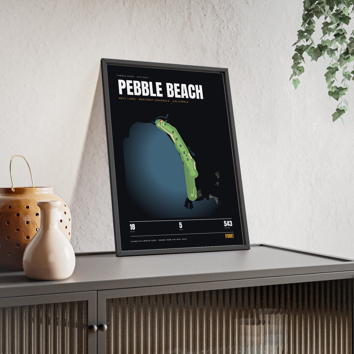 Pebble Beach 18th Hole print framed and leaning on a sideboard