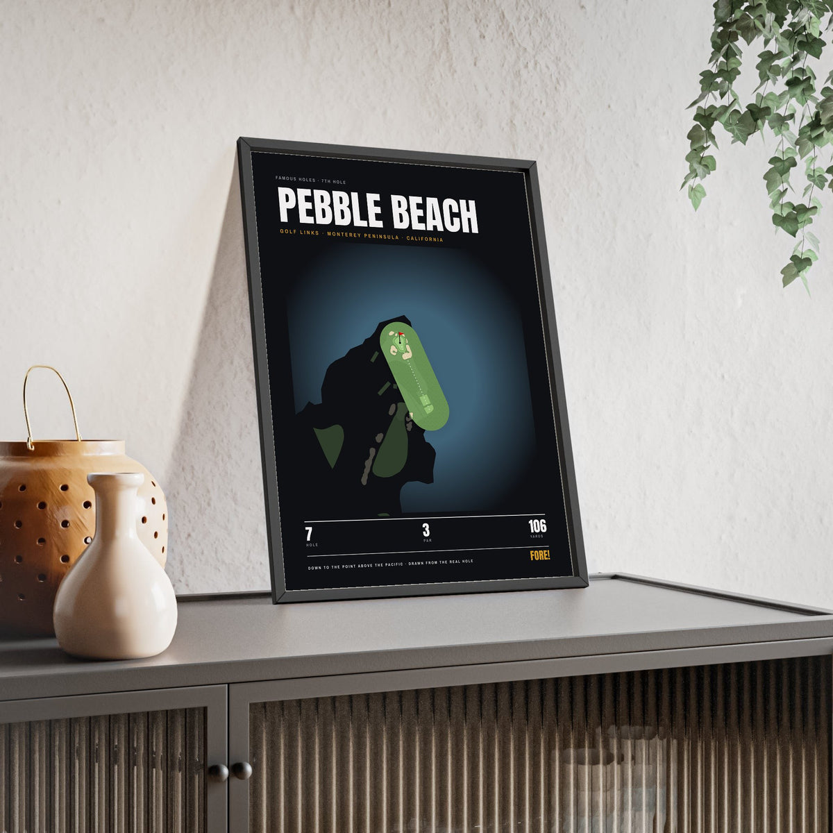 Pebble Beach 7th Hole print framed and leaning on a sideboard