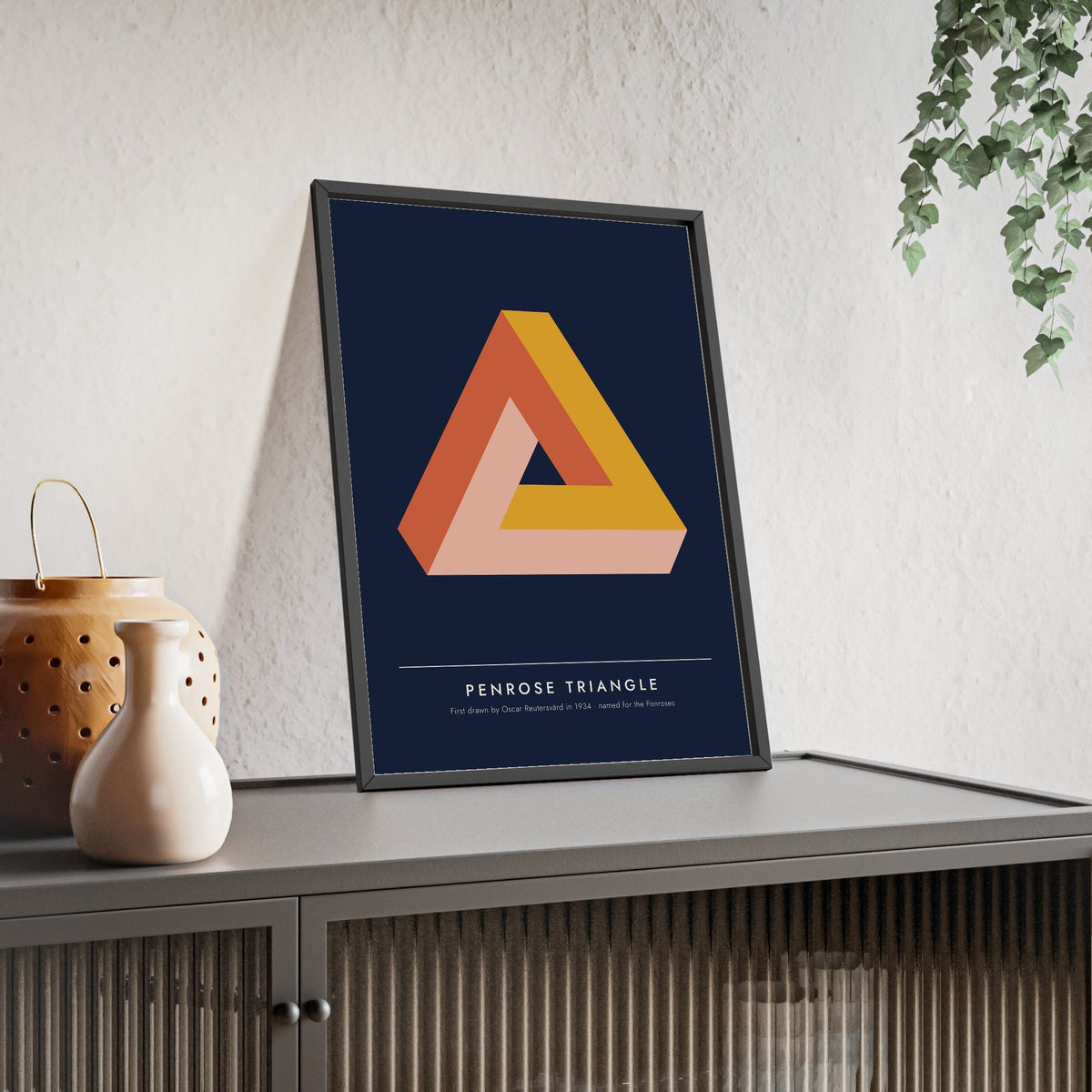 Penrose Triangle print framed and leaning on a sideboard