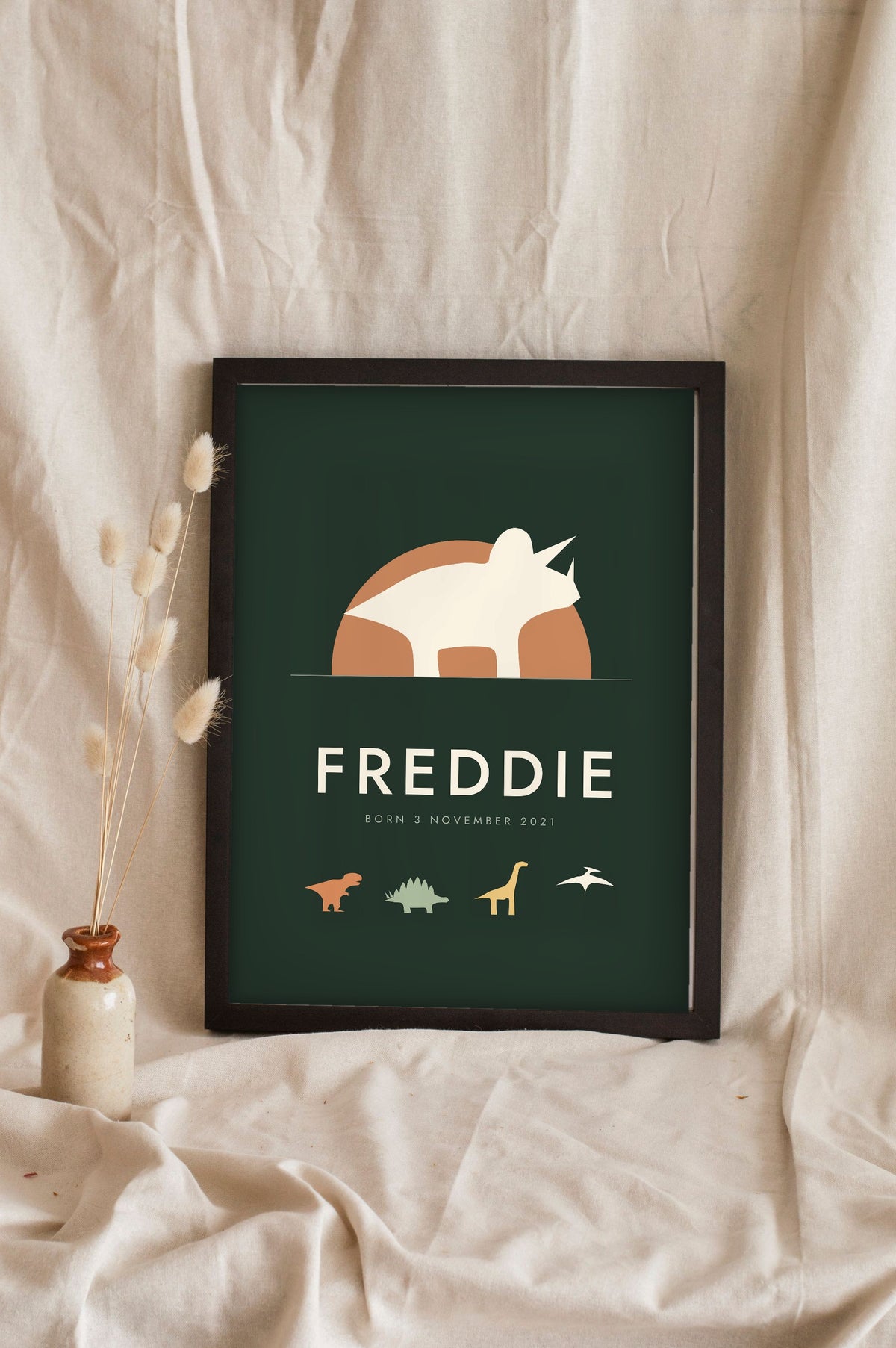 Personalised Dinosaur Name Print - forest green triceratops name print leaning on a shelf