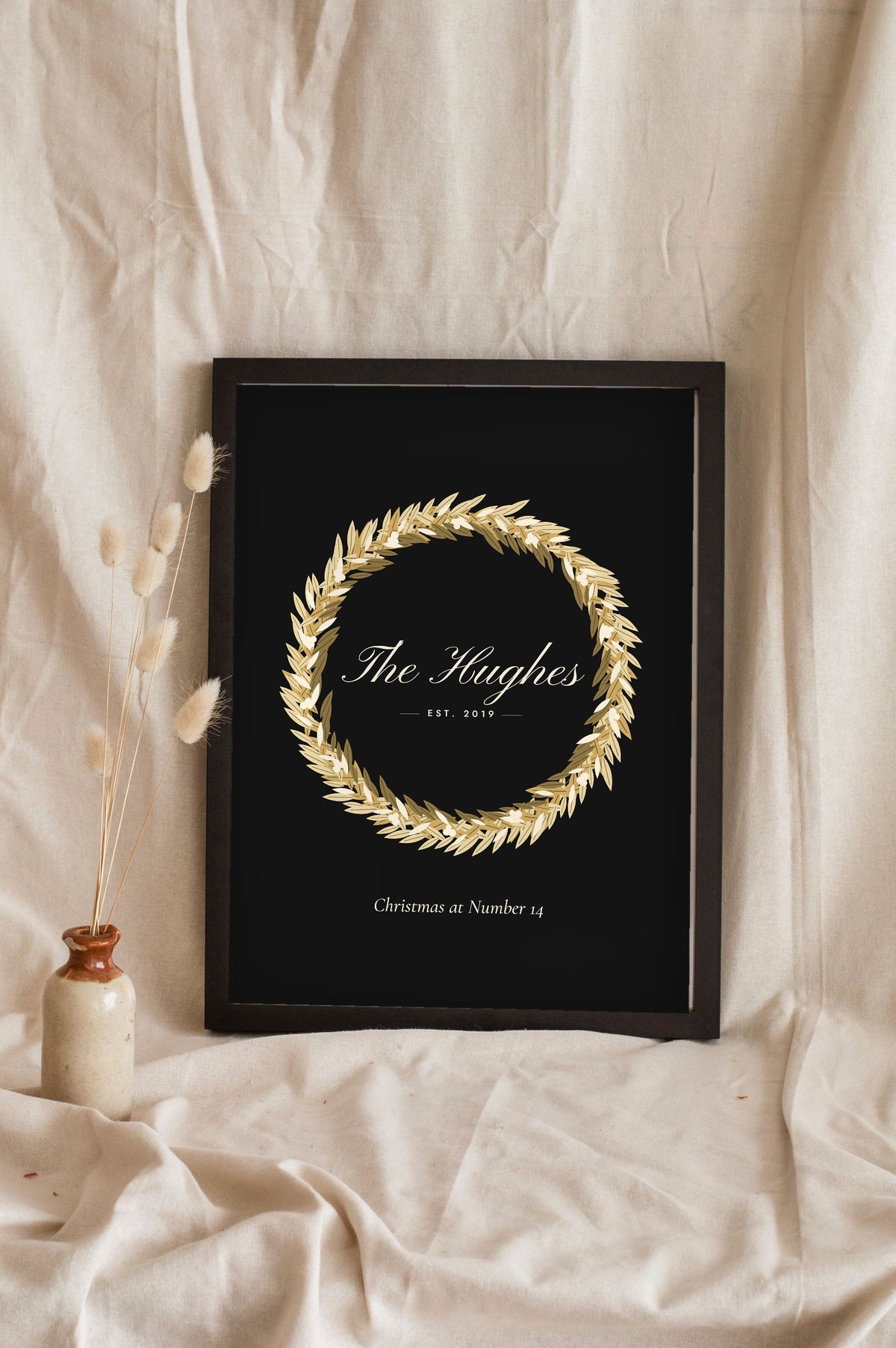 Personalised Christmas Wreath Print - black and gold wreath print leaning on a shelf