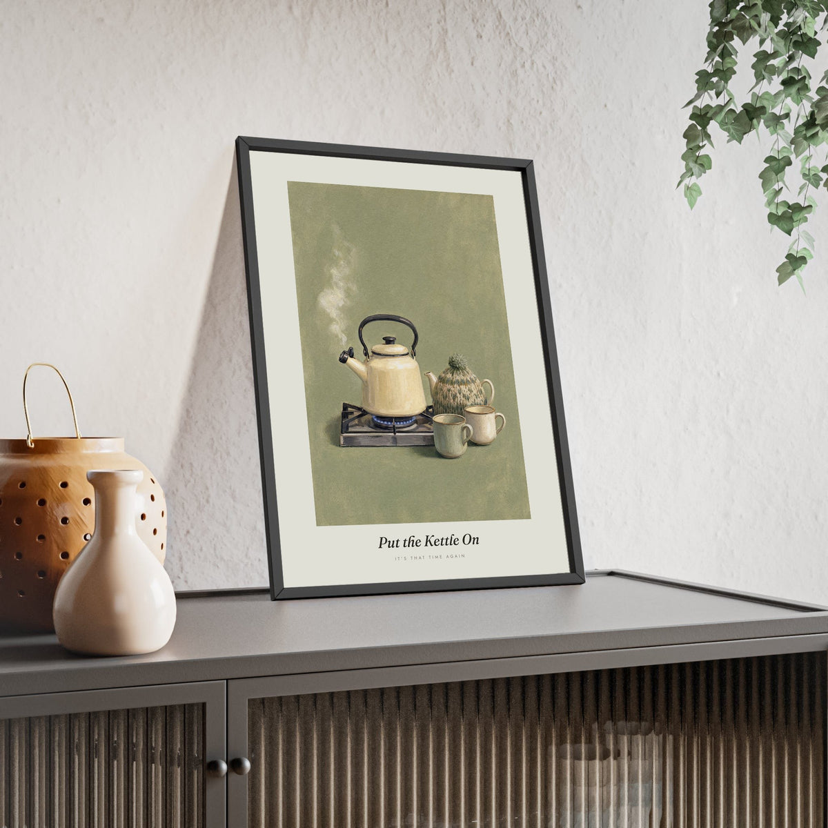 Put the Kettle On Print framed and leaning on a sideboard