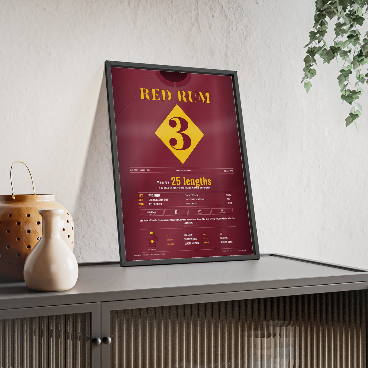 Red Rum Grand National 1977 Horse Racing Poster - Third National Silks Print framed and leaning on a sideboard