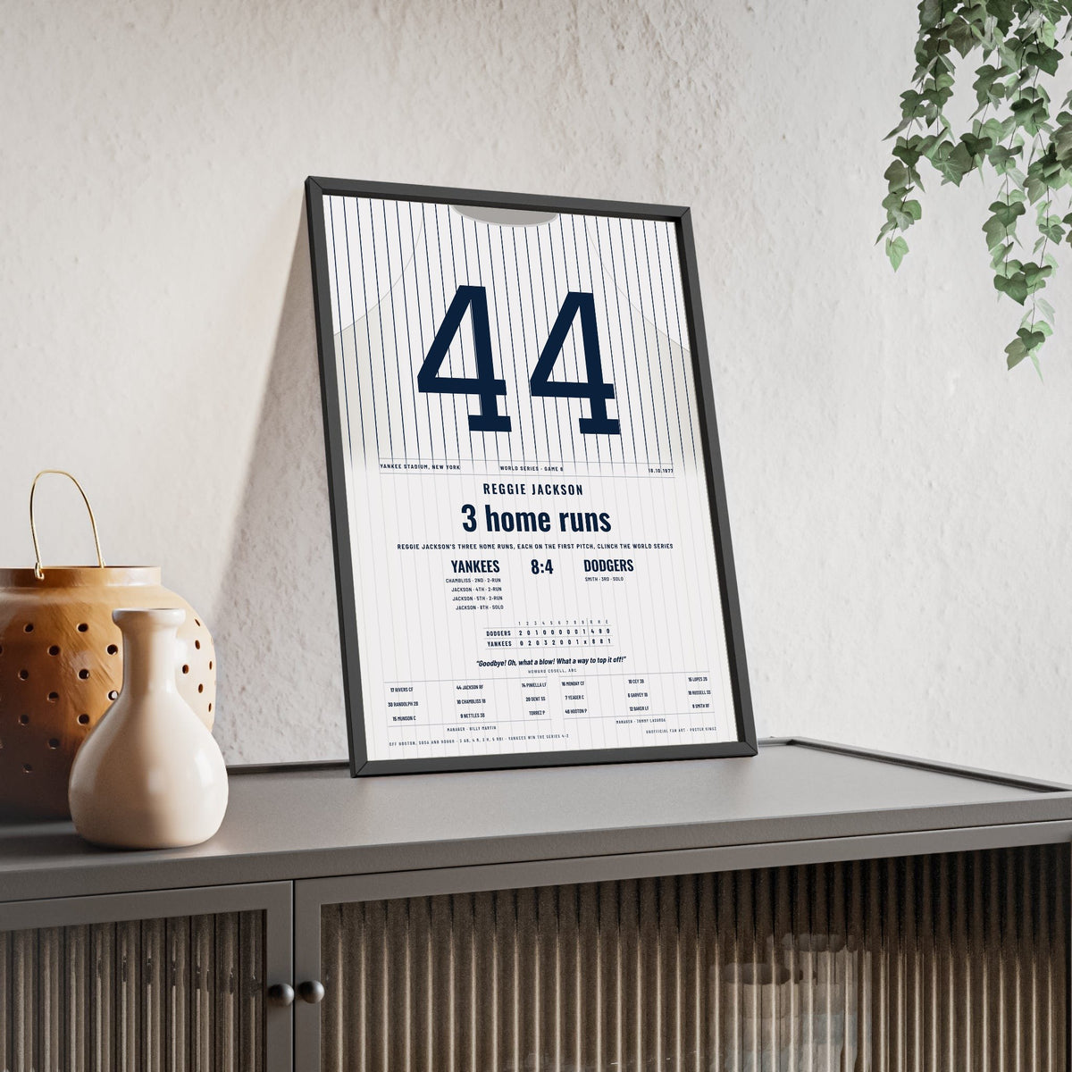 Reggie Jackson 1977 World Series Three Home Runs Poster - New York Yankees 44 Jersey Print framed and leaning on a sideboard