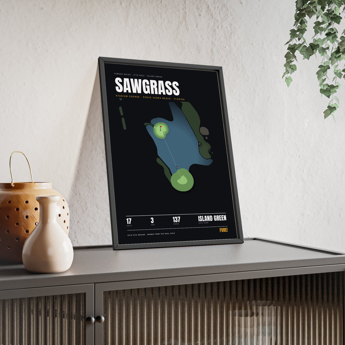 Sawgrass 17th Hole print framed and leaning on a sideboard
