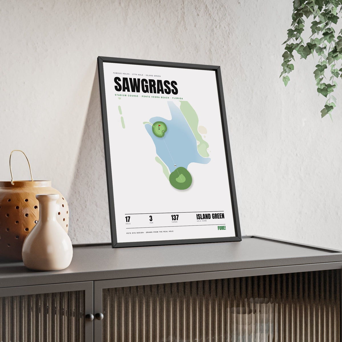 Sawgrass 17th Hole White print framed and leaning on a sideboard