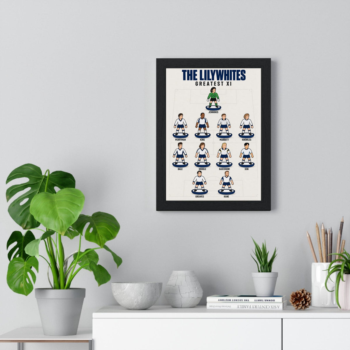 Tottenham Hotspur Greatest XI poster framed on a living room wall