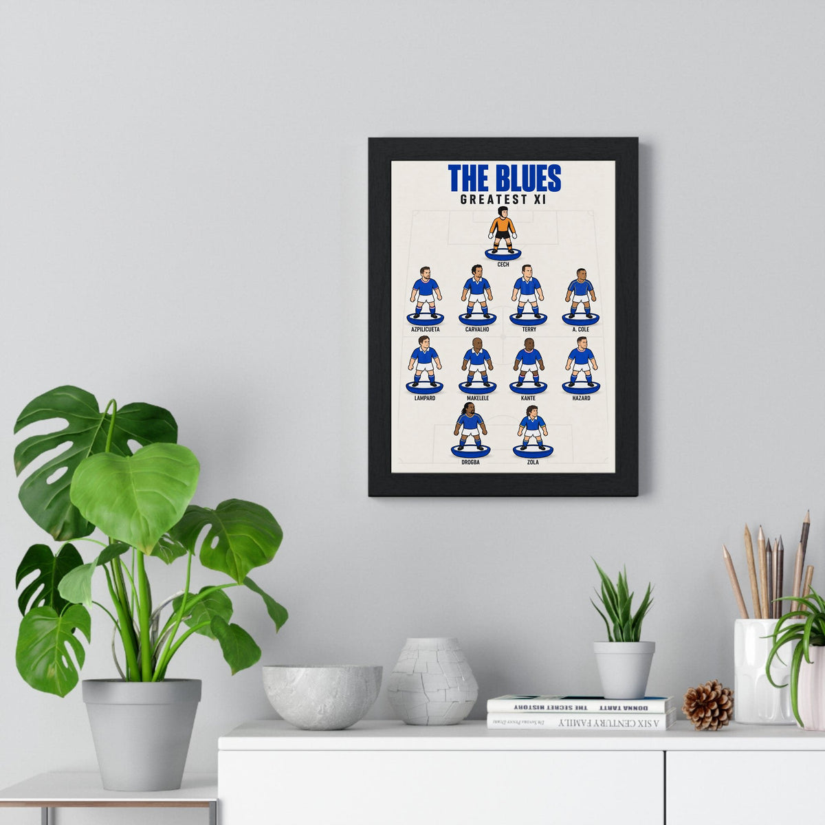Chelsea Greatest XI poster framed on a living room wall