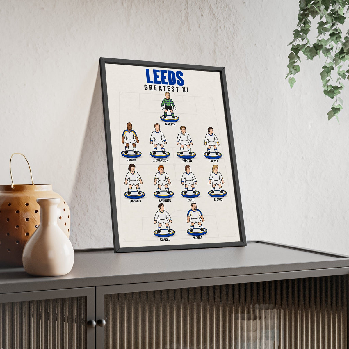 Leeds United Greatest XI framed print leaning on a sideboard