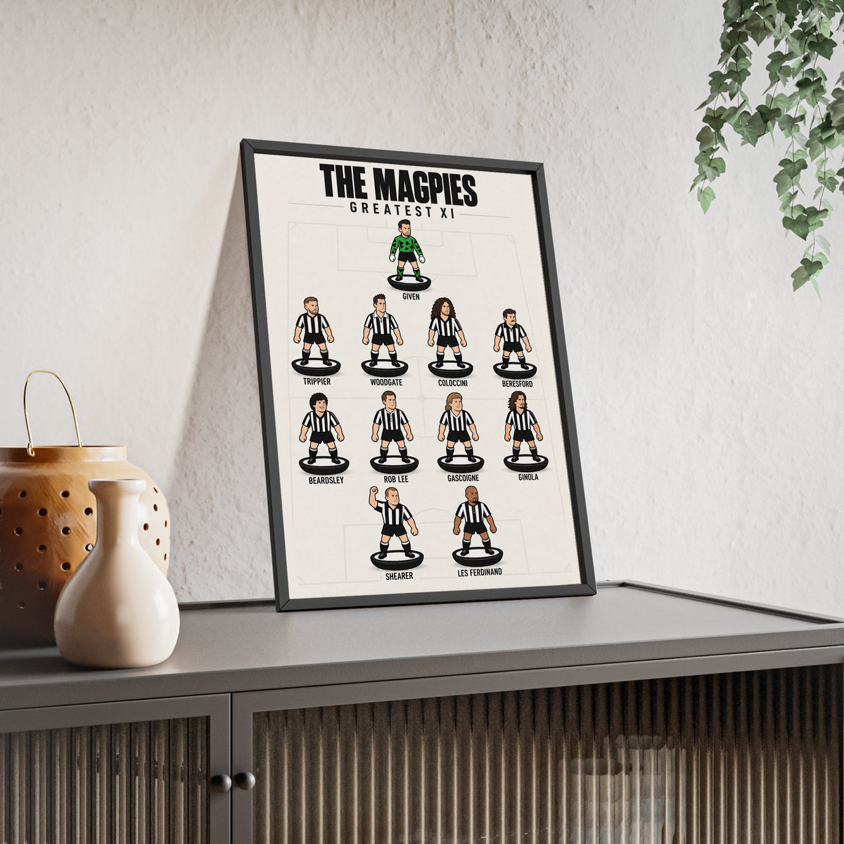 Newcastle United Greatest XI framed print leaning on a sideboard