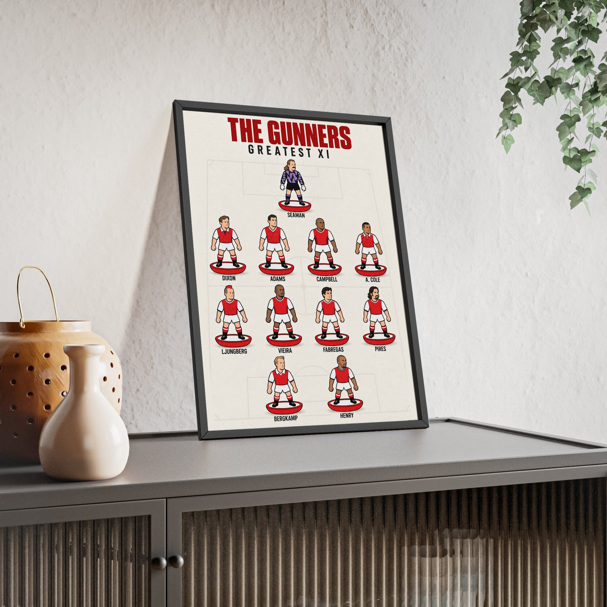 Arsenal Greatest XI framed print leaning on a sideboard