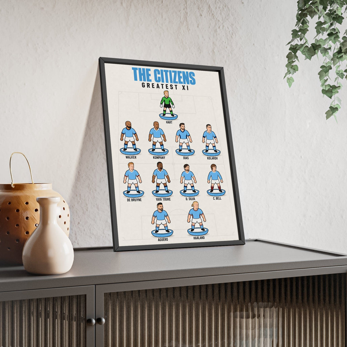 Manchester City Greatest XI framed print leaning on a sideboard