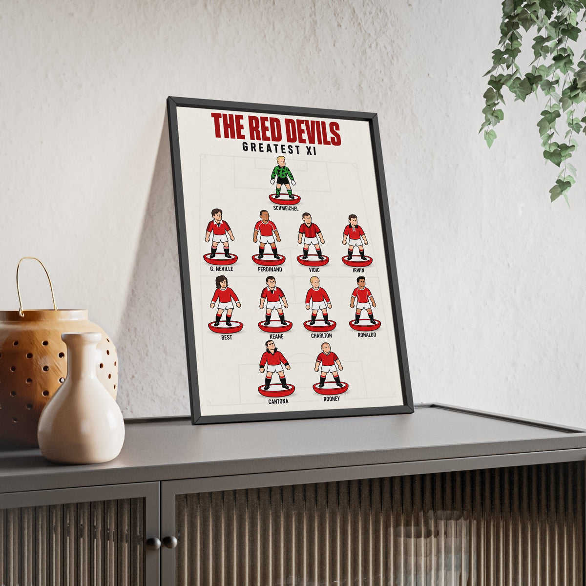 Manchester United Greatest XI framed print leaning on a sideboard