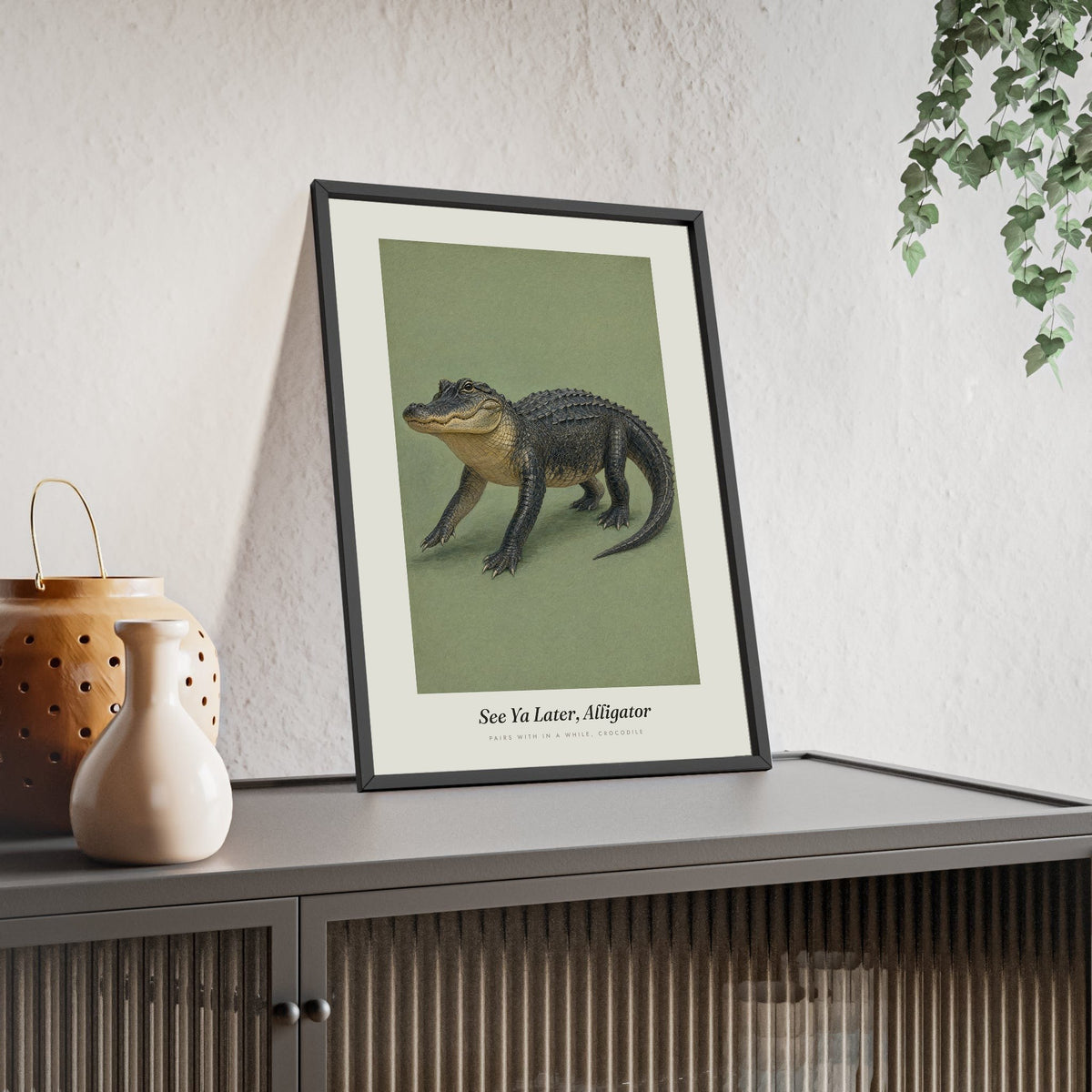 See Ya Later Alligator Print framed and leaning on a sideboard