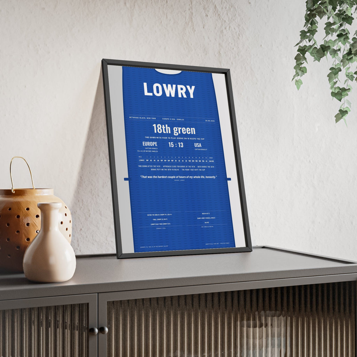 Shane Lowry Bethpage 2025 Golf Poster - Caddie Bib Europe v USA Birdie on 18 Print framed and leaning on a sideboard