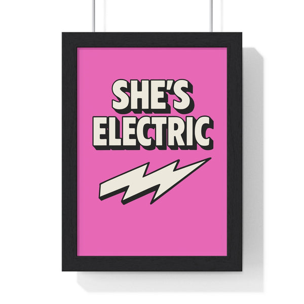 She's Electric inspired poster framed in black, vibrant pink background with bold lightning bolt and retro typography