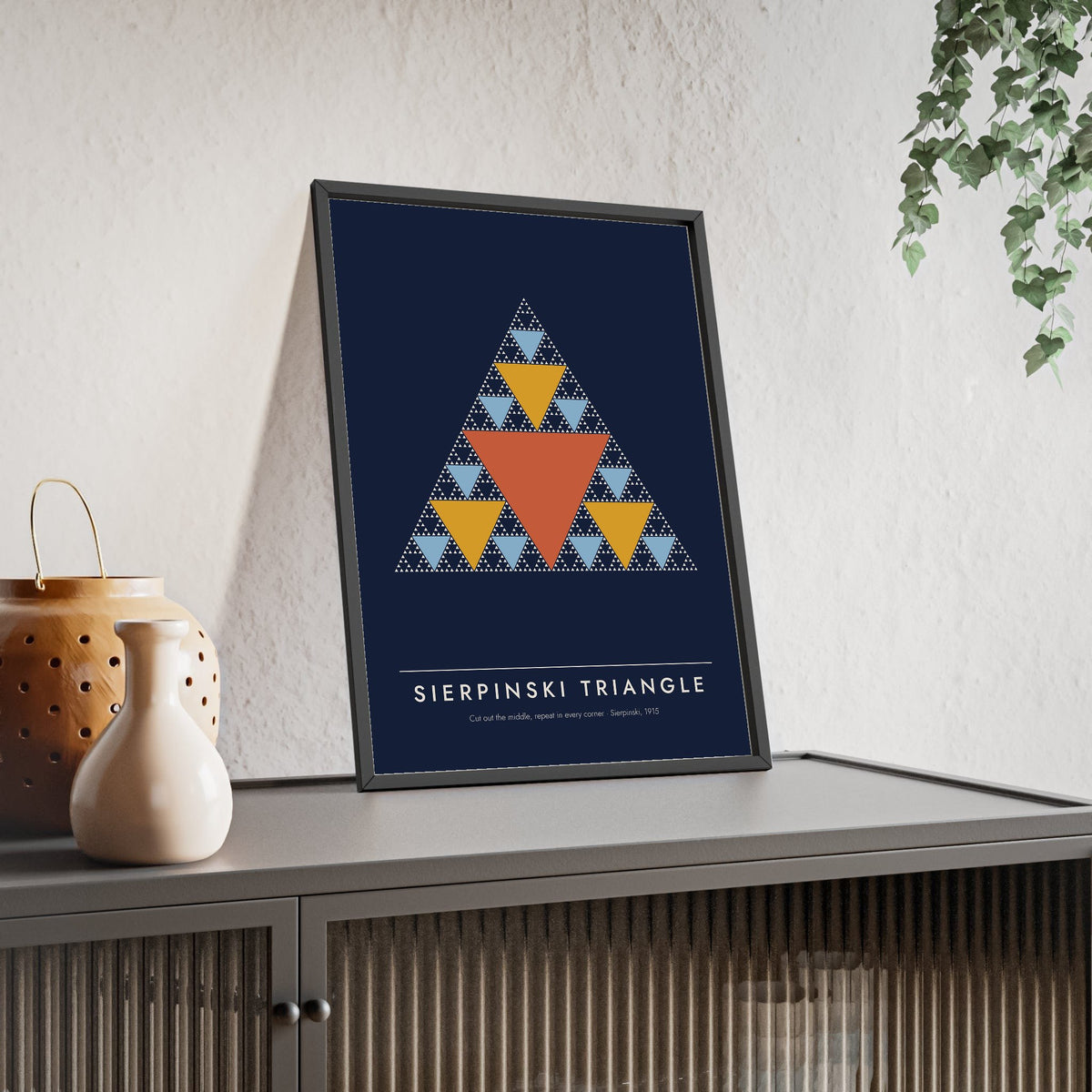 Sierpinski Triangle print framed and leaning on a sideboard