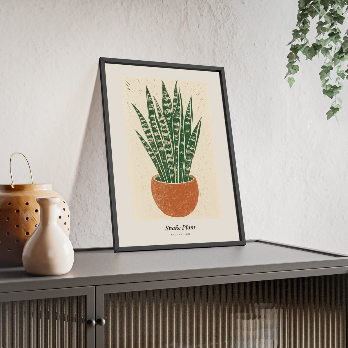 Snake Plant Lino Print framed and leaning on a sideboard