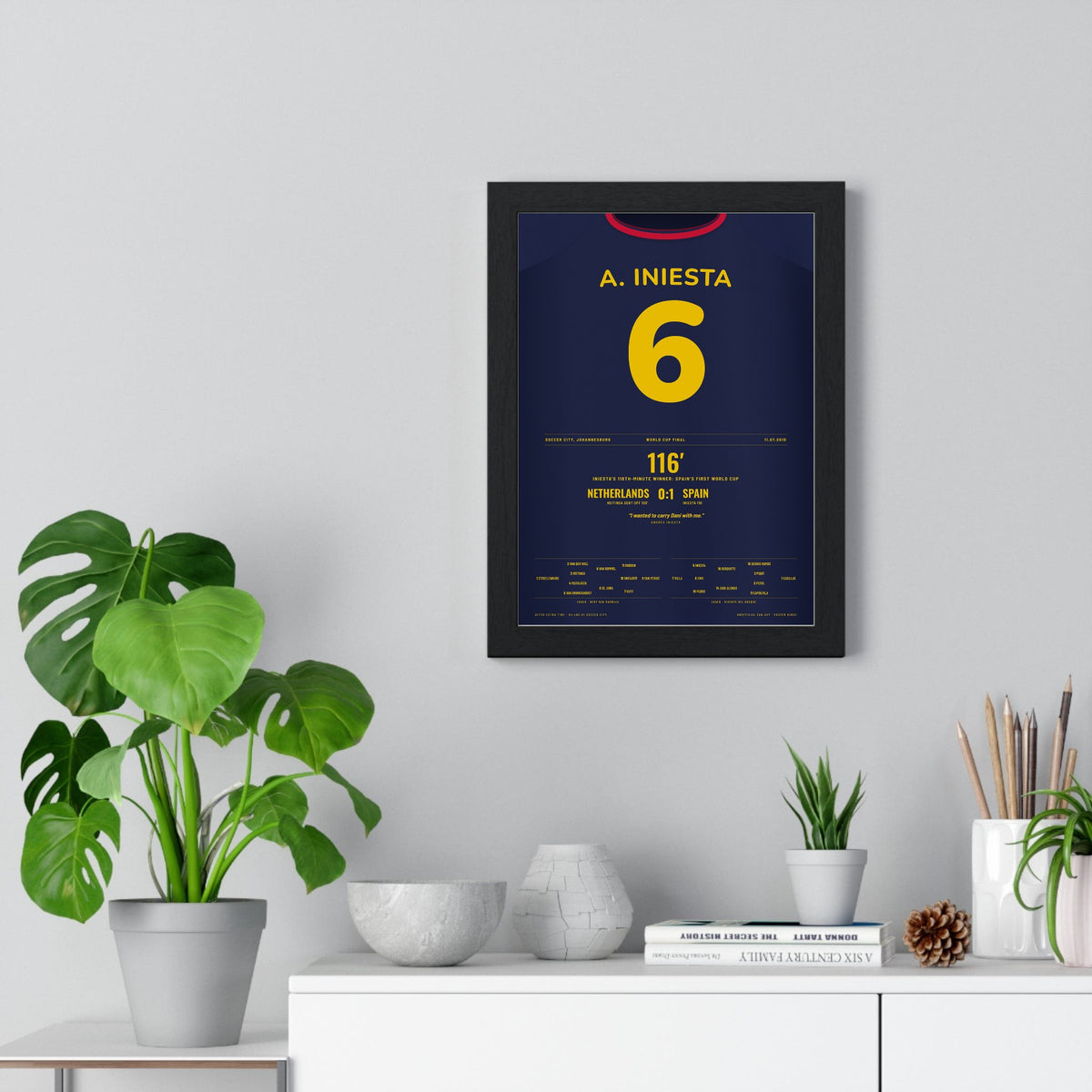 Spain World Cup Final 2010 Poster - Andrés Iniesta 6 116th Minute Winner Shirt Print framed on a living room wall