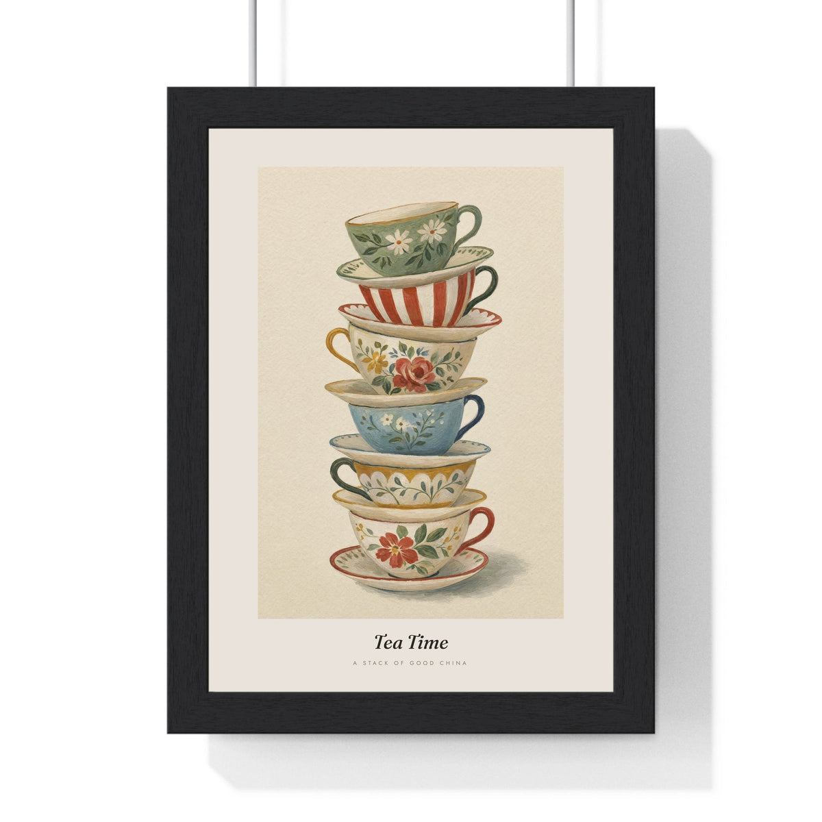 Stacked Teacups Print framed in a black frame, ready to hang