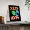Stay Hoppy Neon Print framed and leaning on a sideboard