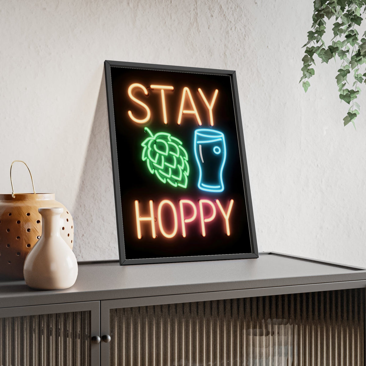 Stay Hoppy Neon Print framed and leaning on a sideboard