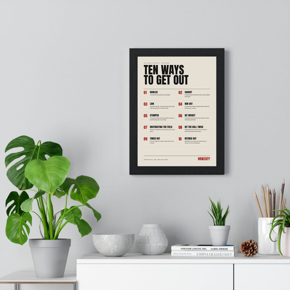 Ten Ways To Get Out Cricket print framed on a living room wall