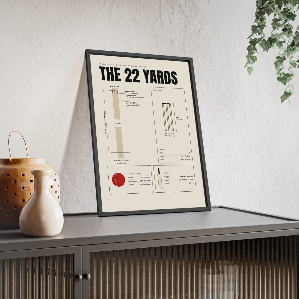 The 22 Yards Cricket Pitch print framed and leaning on a sideboard