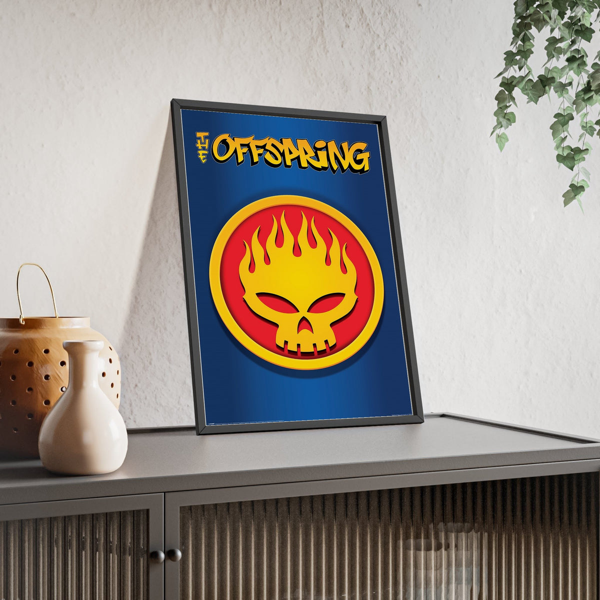 The Offspring Conspiracy of One Maxi Poster framed and leaning on a sideboard