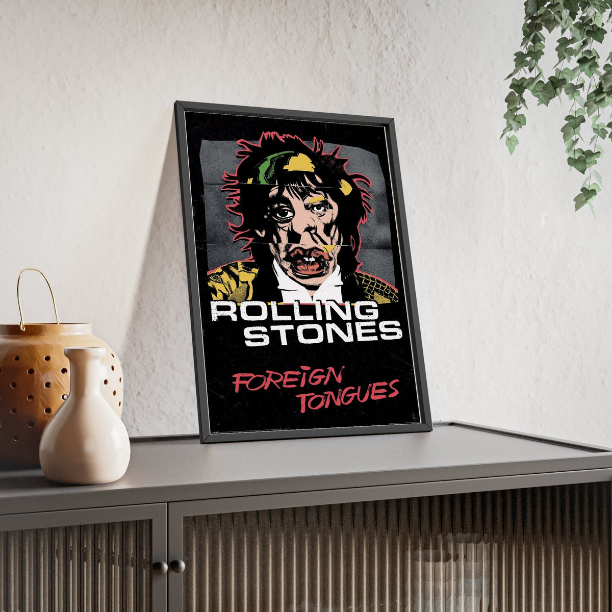 The Rolling Stones Foreign Tongues Maxi Poster framed and leaning on a sideboard