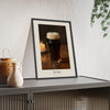 The Stout Print framed and leaning on a sideboard