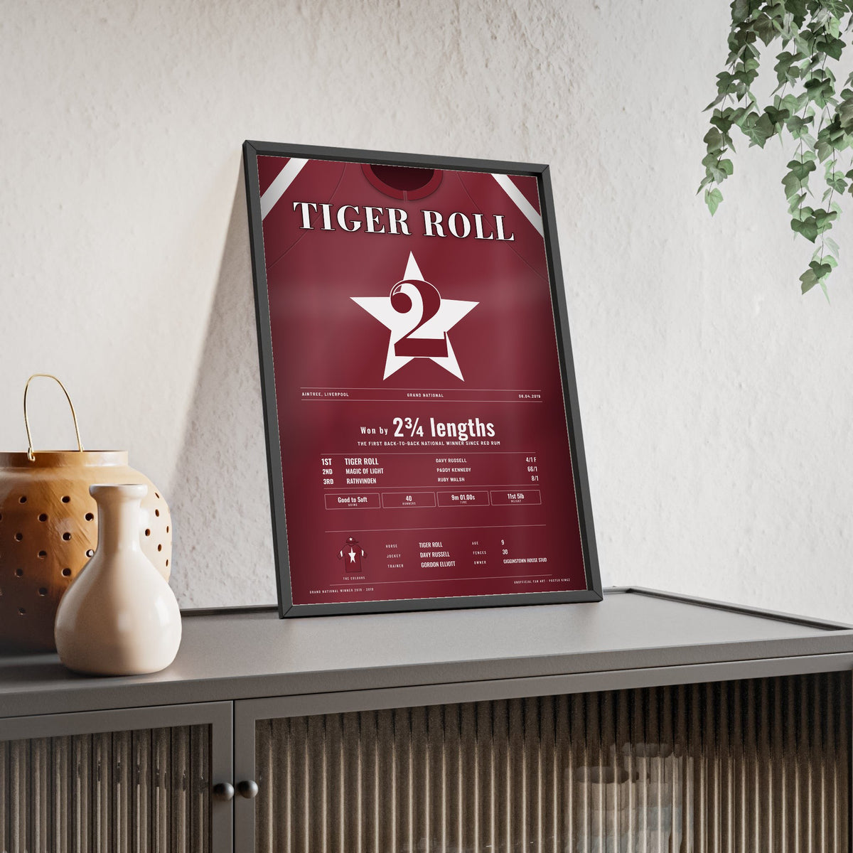 Tiger Roll Grand National 2019 Horse Racing Poster - Back to Back Nationals Silks Print framed and leaning on a sideboard