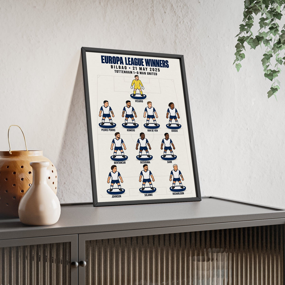 Tottenham Hotspur Europa League 2025 XI framed print leaning on a sideboard